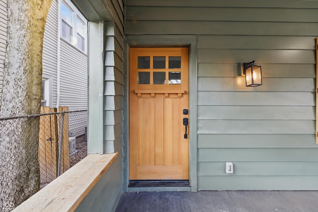 entrance to property featuring fence