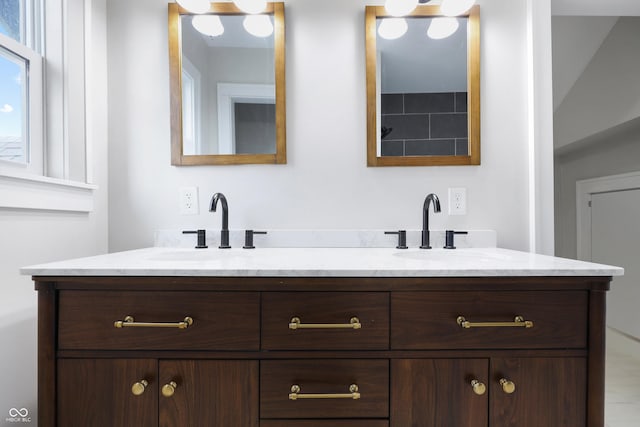 bathroom with double vanity and a sink