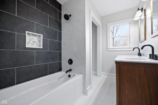 bathroom with baseboards,  shower combination, and vanity