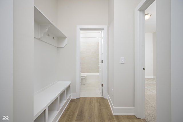 mudroom featuring baseboards and wood finished floors