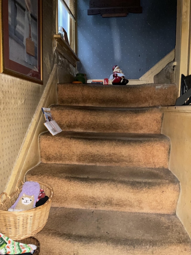 stairway with wallpapered walls