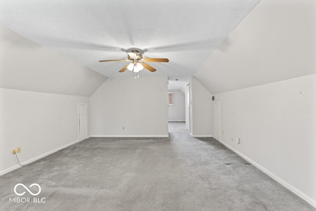 2447 N E Raintree Dr, New Castle, IN 47362 - additional living space featuring ceiling fan, carpet flooring, vaulted ceiling, and a textured ceiling