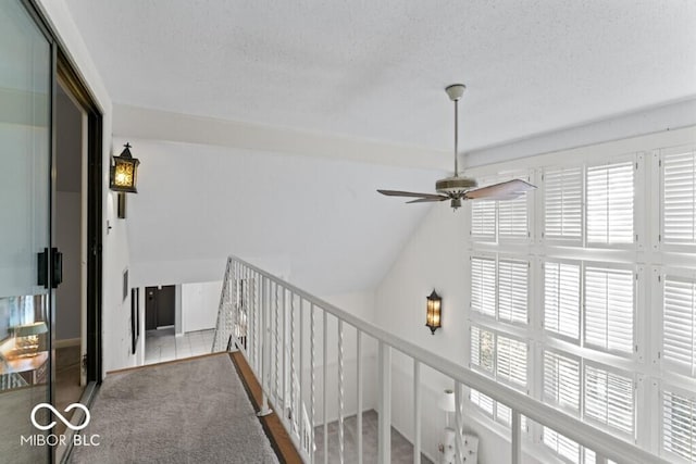 2447 N E Raintree Dr, New Castle, IN 47362 - hallway with carpet, a textured ceiling, an upstairs landing, and vaulted ceiling