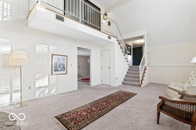 2447 N E Raintree Dr, New Castle, IN 47362 - carpeted entrance foyer featuring stairs and a towering ceiling