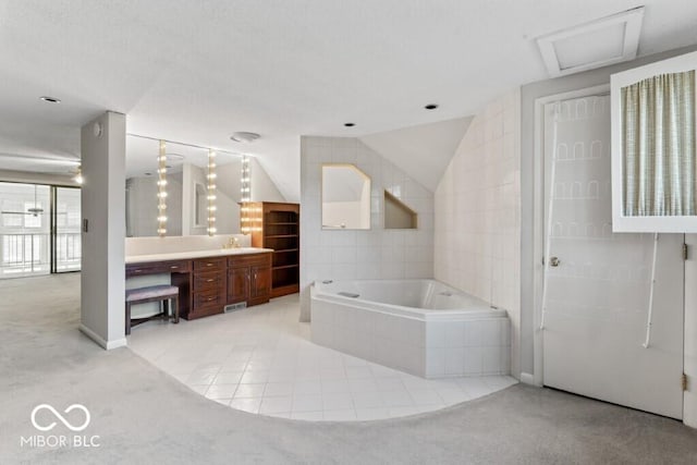 2447 N E Raintree Dr, New Castle, IN 47362 - bathroom featuring a garden tub, vanity, vaulted ceiling, and tile patterned floors