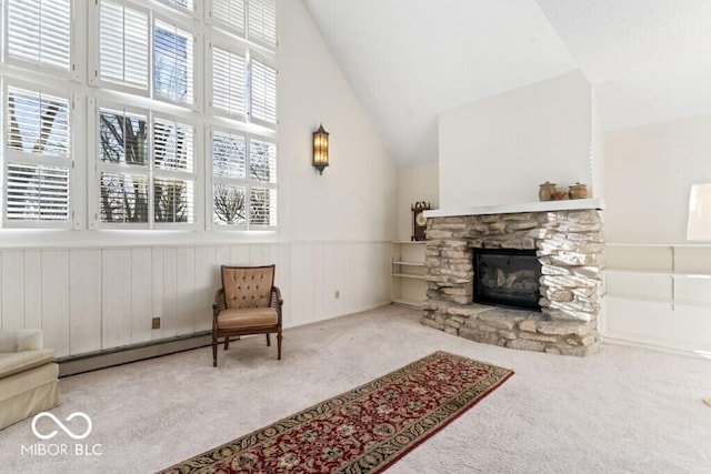 2447 N E Raintree Dr, New Castle, IN 47362 - living room with carpet flooring, a baseboard heating unit, high vaulted ceiling, a wainscoted wall, and a stone fireplace