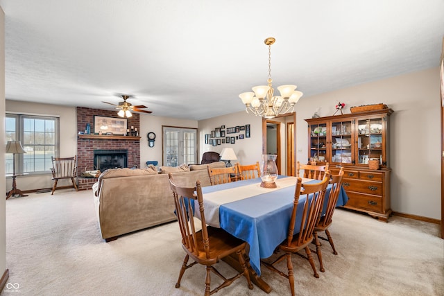 dining area with light carpet, a fireplace, and baseboards