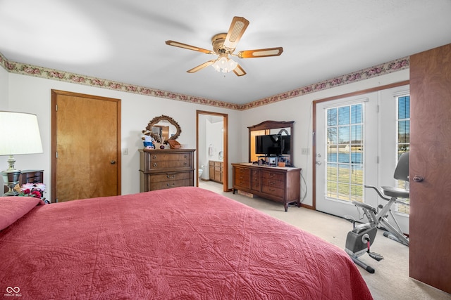 bedroom featuring a ceiling fan, ensuite bath, access to outside, and light colored carpet