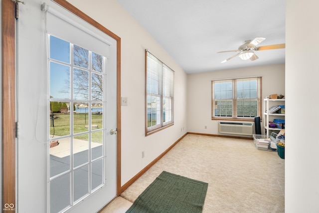 entryway with a ceiling fan, carpet, baseboards, and a wall mounted air conditioner