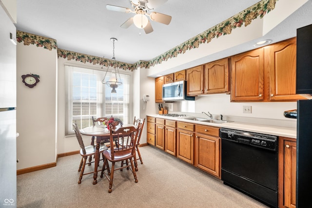 kitchen with a ceiling fan, baseboards, a sink, dishwasher, and stainless steel microwave