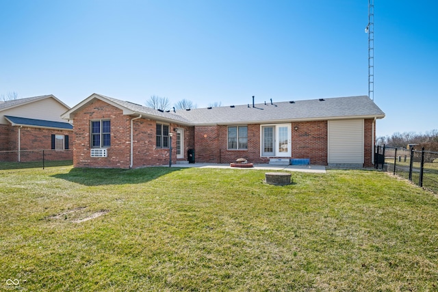 rear view of house with a patio area, brick siding, a fenced backyard, and an outdoor fire pit