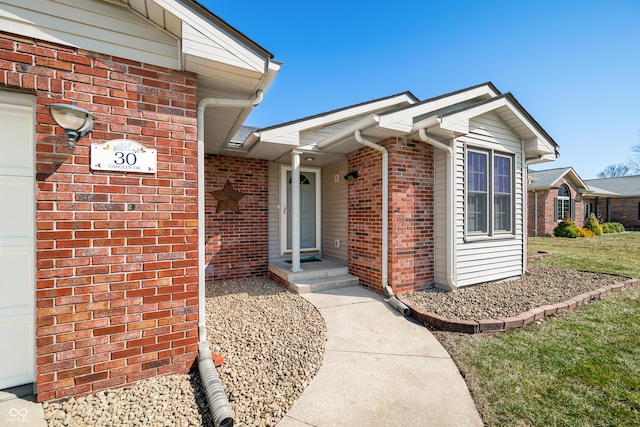 doorway to property with brick siding