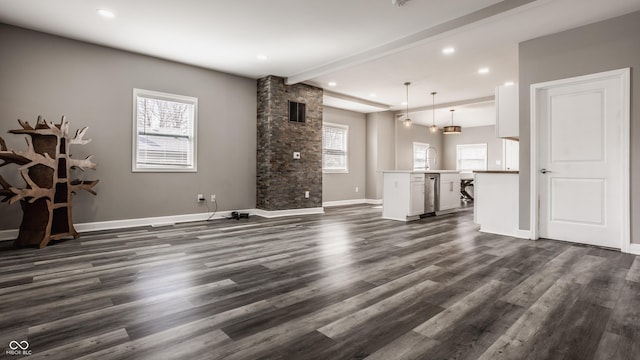 unfurnished living room with baseboards, visible vents, recessed lighting, dark wood-type flooring, and beamed ceiling