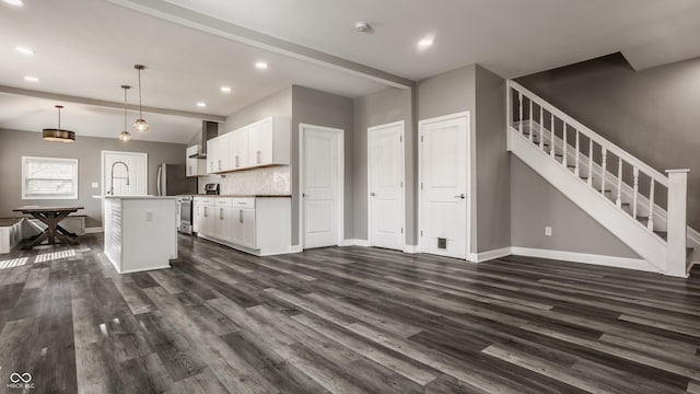 unfurnished living room with recessed lighting, stairway, baseboards, and dark wood finished floors