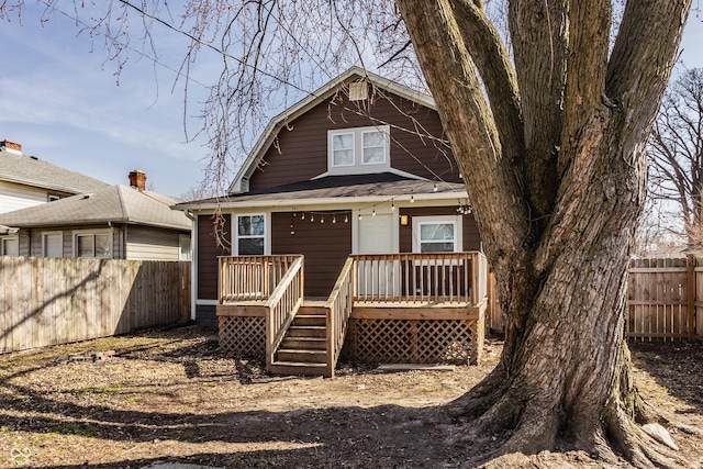 view of front of property with fence and a wooden deck