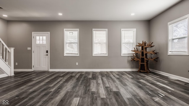 foyer entrance featuring stairway, plenty of natural light, and baseboards