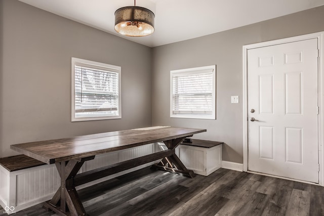 dining area featuring dark wood-style floors and baseboards