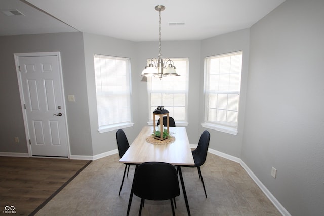 dining room featuring visible vents, baseboards, light wood-style floors, and an inviting chandelier