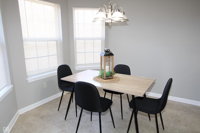 dining space with a notable chandelier and baseboards