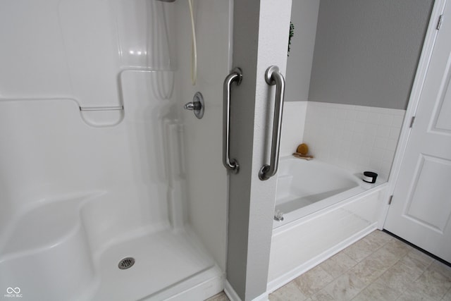 bathroom with a garden tub and a stall shower