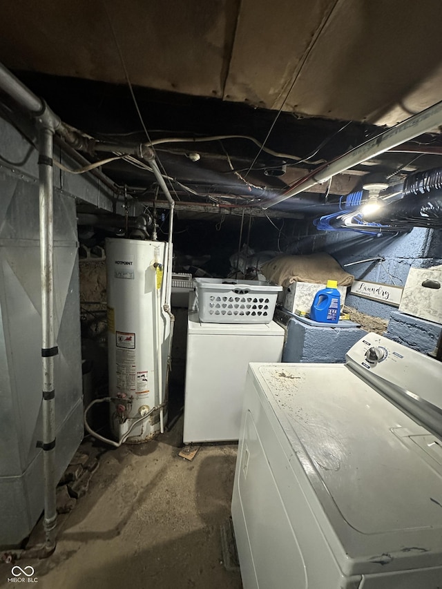 washroom featuring washer and dryer, laundry area, heating unit, and water heater