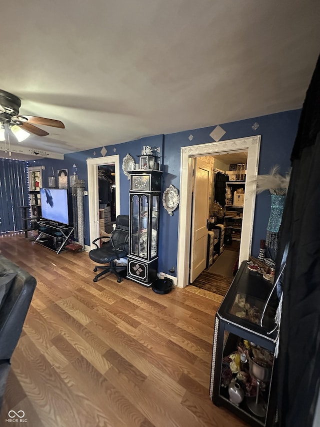 interior space featuring wood finished floors and ceiling fan