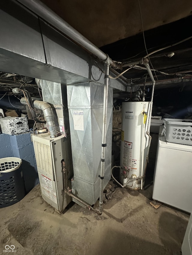 utility room with gas water heater, heating unit, and washer / clothes dryer