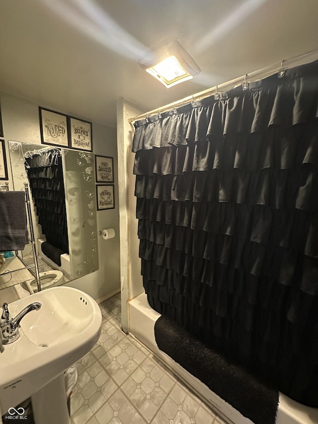 full bathroom with a sink and shower / bathtub combination with curtain