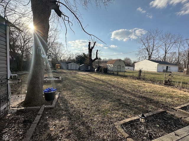 view of yard with an outdoor structure and fence