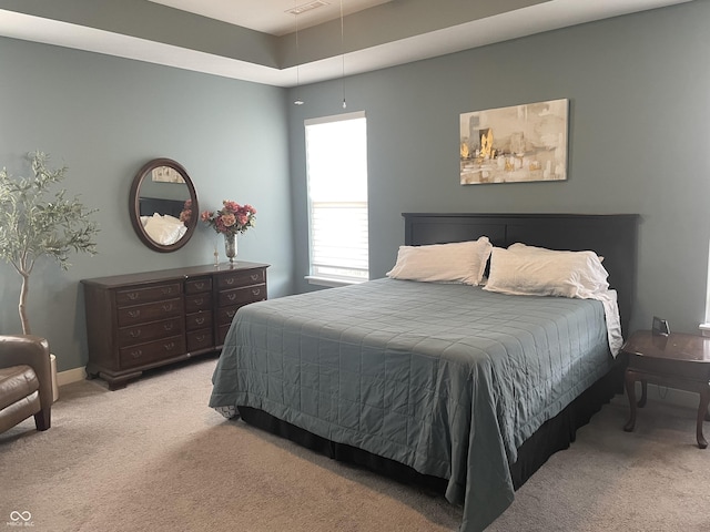 bedroom featuring attic access and carpet floors