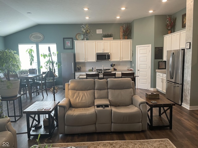 kitchen featuring dark wood finished floors, decorative backsplash, appliances with stainless steel finishes, white cabinetry, and open floor plan