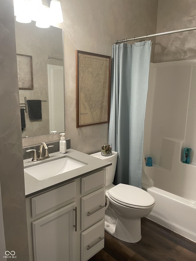 full bath with toilet, wood finished floors, vanity, and shower / bath combination with curtain