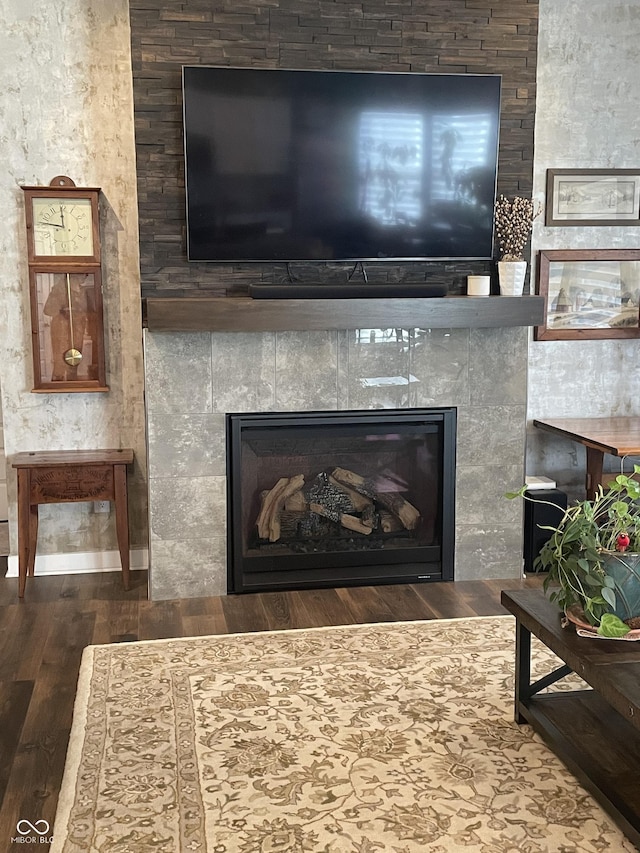 room details featuring wood finished floors and a tile fireplace