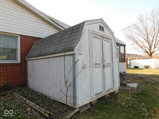 view of shed featuring fence