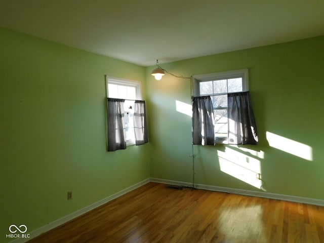 empty room with wood finished floors and baseboards