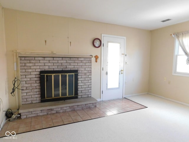 unfurnished living room with visible vents, baseboards, carpet flooring, and a fireplace