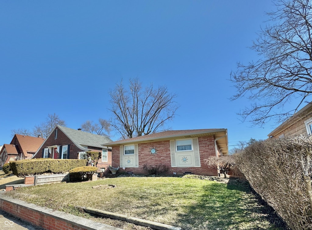 view of front of property with a front yard and brick siding