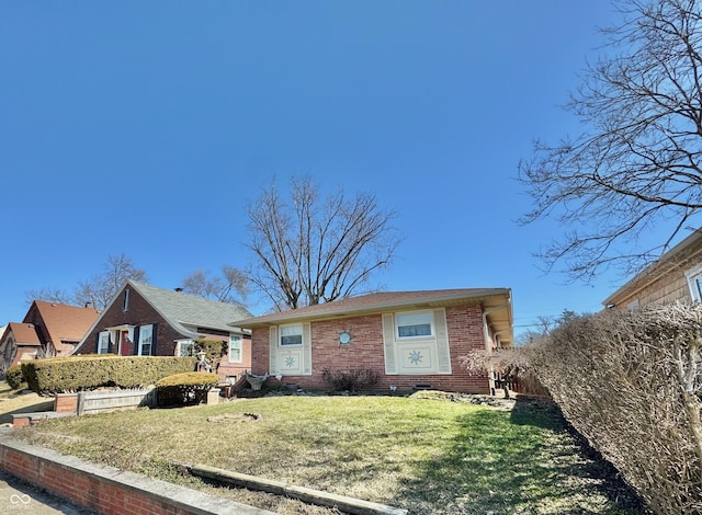 view of front of property with a front yard and brick siding