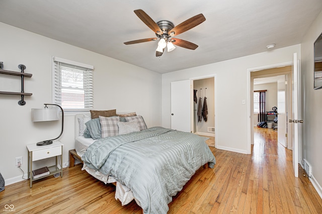 bedroom with visible vents, ceiling fan, light wood-type flooring, and baseboards