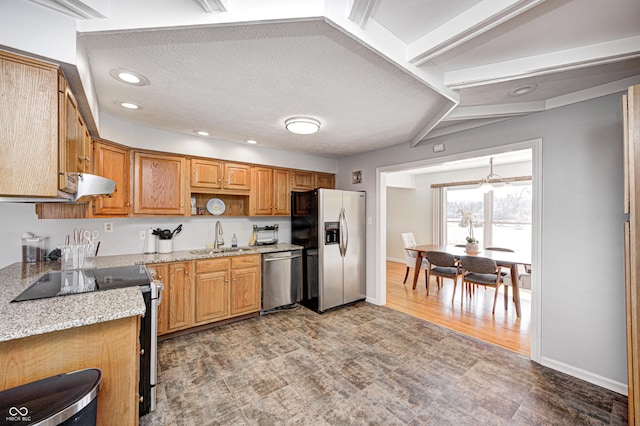 kitchen featuring range hood, light stone countertops, open shelves, a sink, and stainless steel appliances