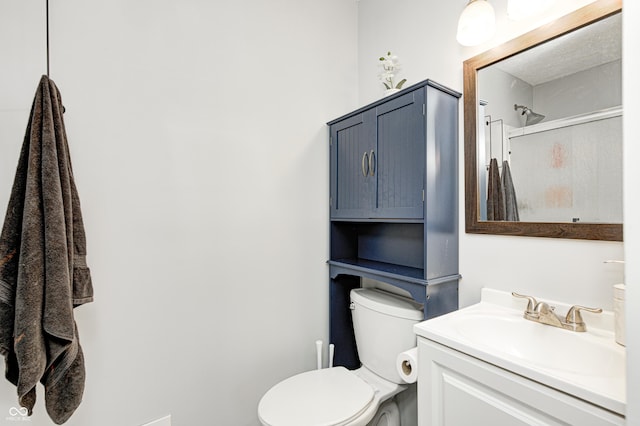 bathroom featuring toilet, an enclosed shower, and vanity