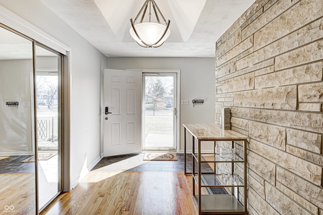 foyer with baseboards and hardwood / wood-style flooring