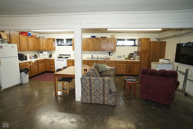 living area featuring concrete block wall and finished concrete flooring