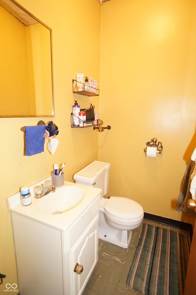 half bath featuring toilet and vanity