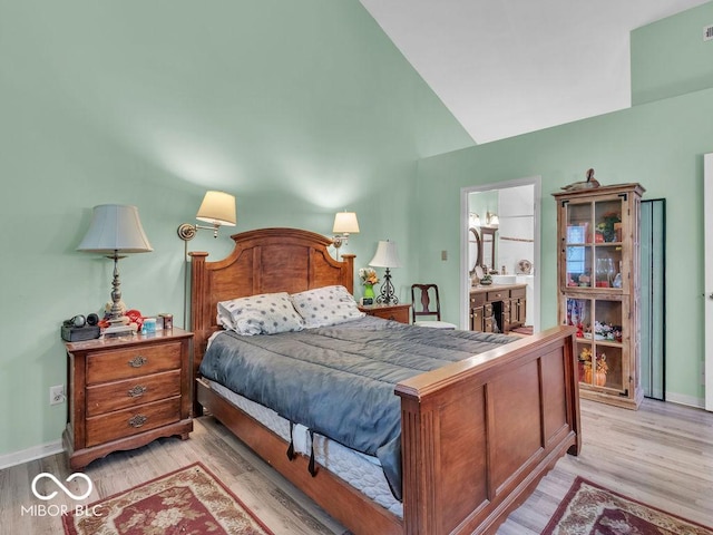 6556 Aintree Ter, Indianapolis, IN 46250 - bedroom with lofted ceiling, light wood finished floors, and baseboards