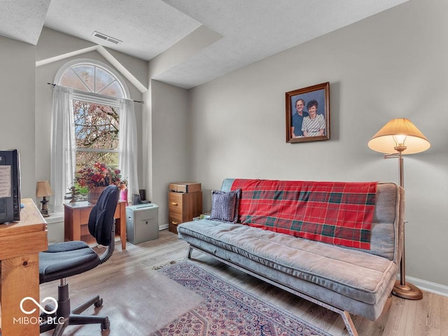 6556 Aintree Ter, Indianapolis, IN 46250 - home office featuring a textured ceiling, visible vents, wood finished floors, and baseboards