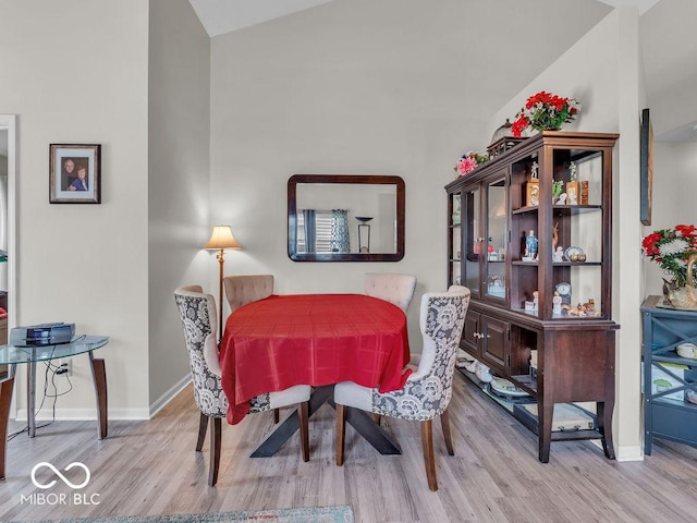 6556 Aintree Ter, Indianapolis, IN 46250 - dining space with lofted ceiling, wood finished floors, and baseboards