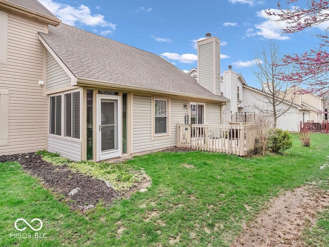 6556 Aintree Ter, Indianapolis, IN 46250 - back of property with a chimney, roof with shingles, a wooden deck, and a lawn