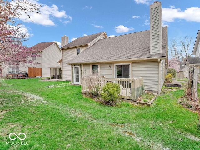 6556 Aintree Ter, Indianapolis, IN 46250 - rear view of property featuring fence, roof with shingles, a chimney, and a yard