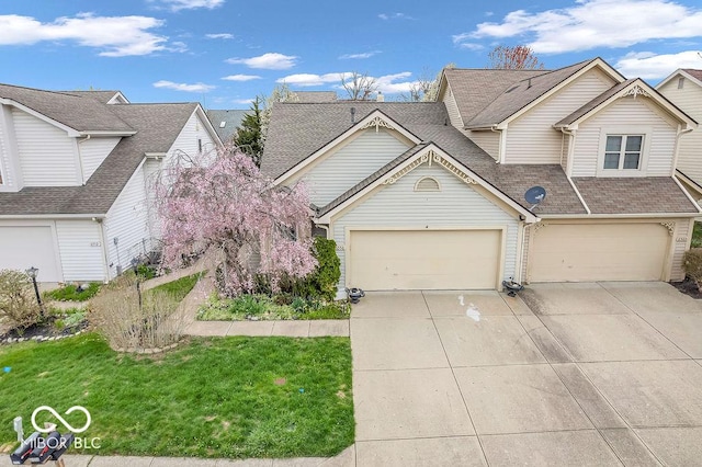 6556 Aintree Ter, Indianapolis, IN 46250 - view of front of house with roof with shingles, driveway, and a front yard